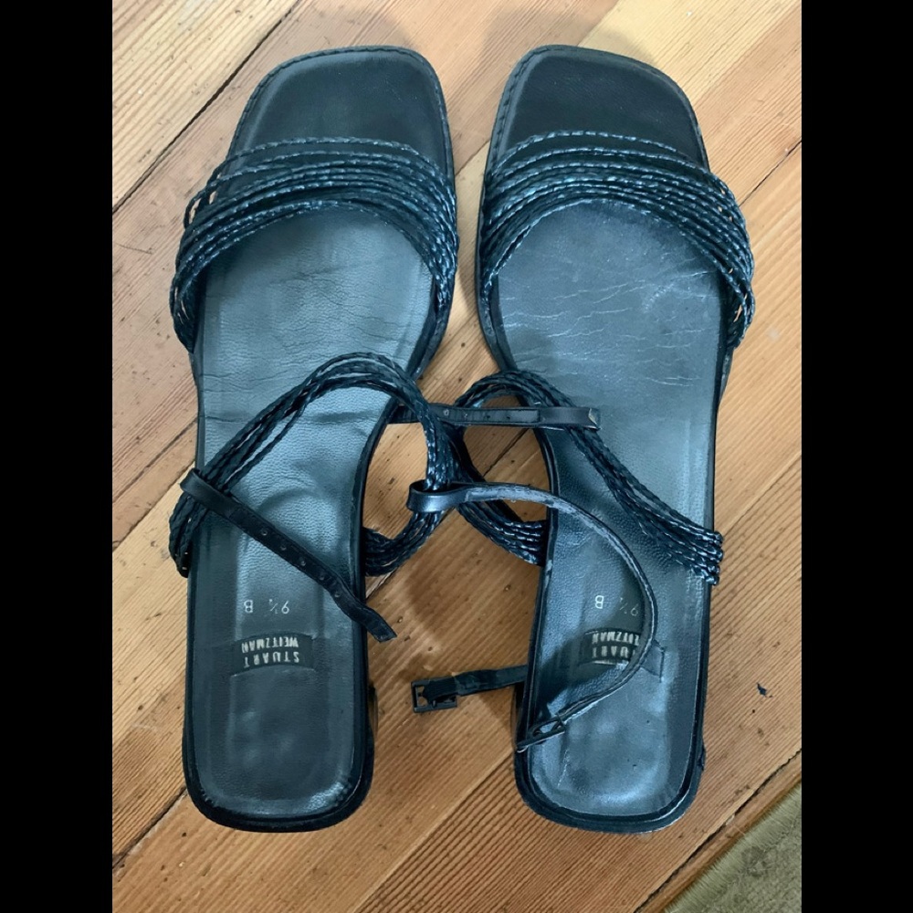 Stuart Weitzman black sandals with a low heel.